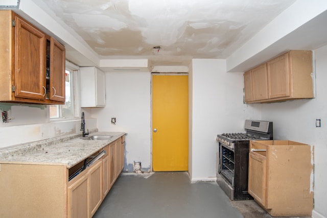 kitchen with concrete flooring, gas stove, and sink