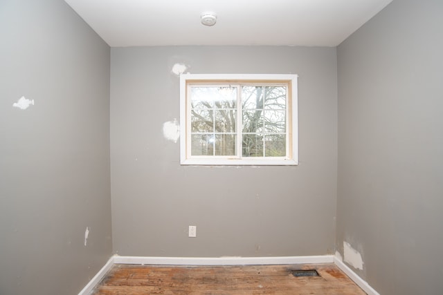 empty room with wood-type flooring