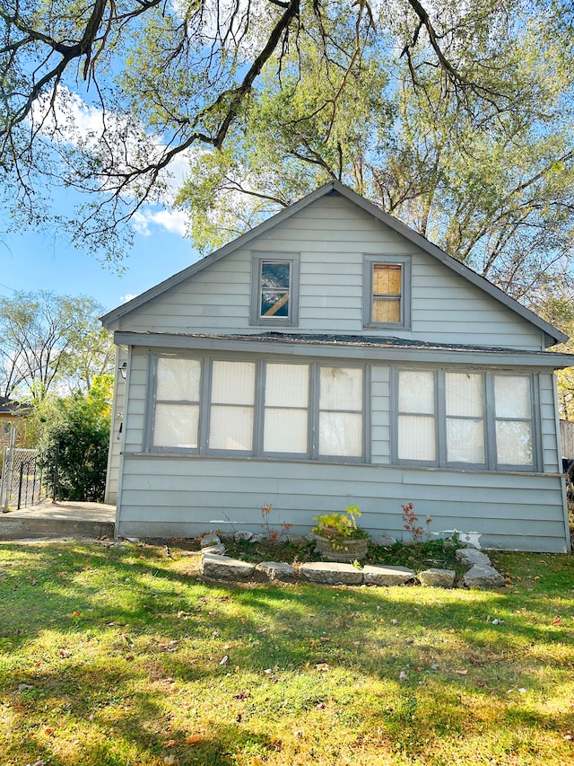 view of side of home featuring a lawn