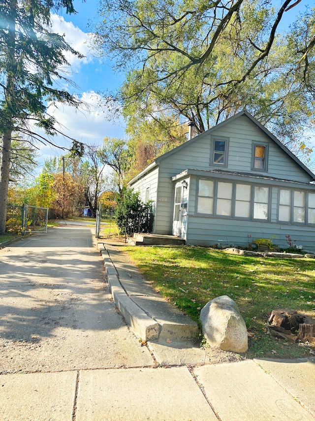 view of property exterior featuring a lawn