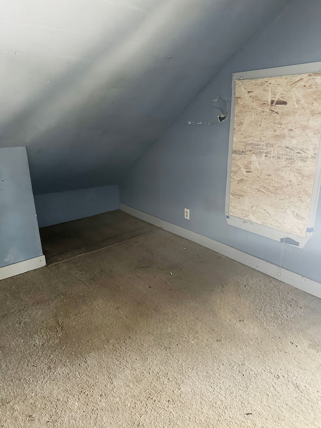 bonus room with carpet flooring and lofted ceiling