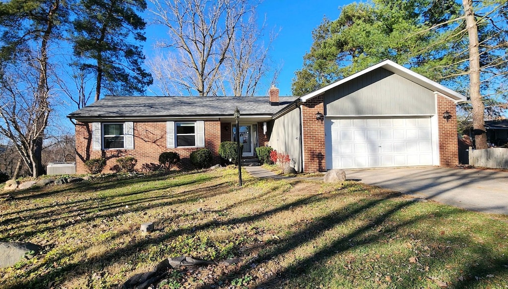 ranch-style house featuring a garage and a front yard