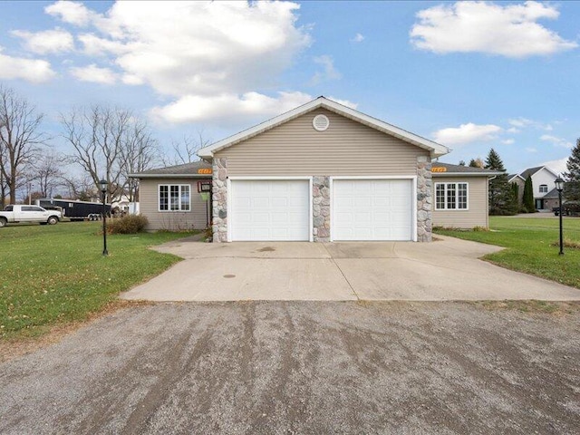 single story home featuring a garage and a front yard