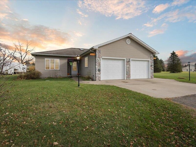 single story home featuring a yard and a garage