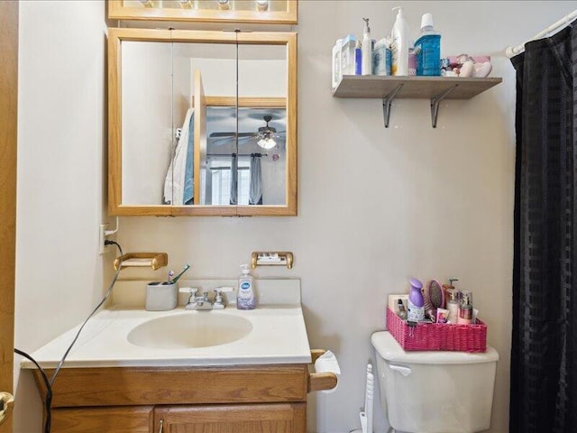 bathroom with ceiling fan, toilet, and vanity