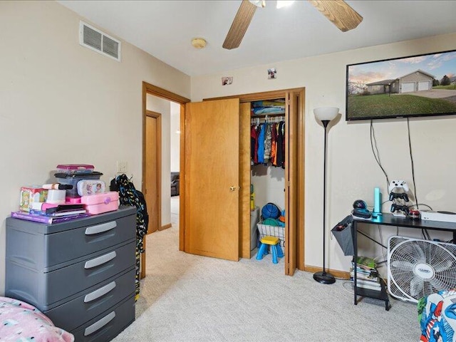 carpeted bedroom with a closet and ceiling fan