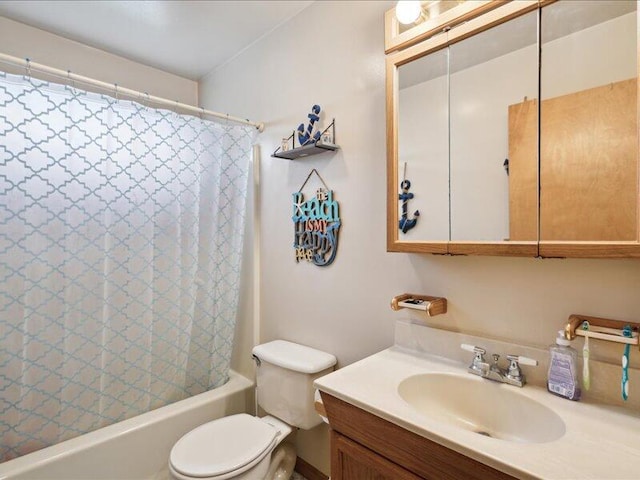 full bathroom with vanity, shower / tub combo, and toilet