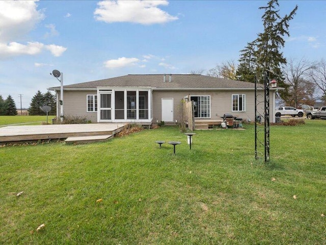 back of house with a deck and a lawn