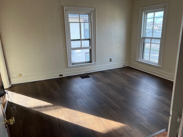 unfurnished room featuring dark hardwood / wood-style floors