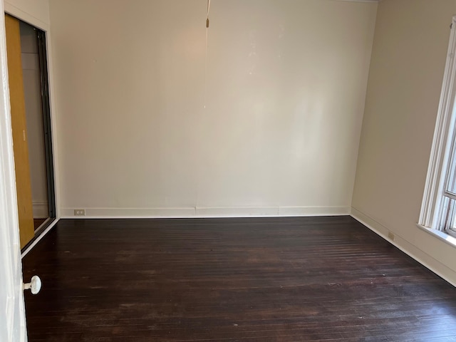 empty room with dark wood-type flooring