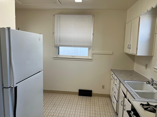 kitchen featuring white cabinets, white appliances, and sink