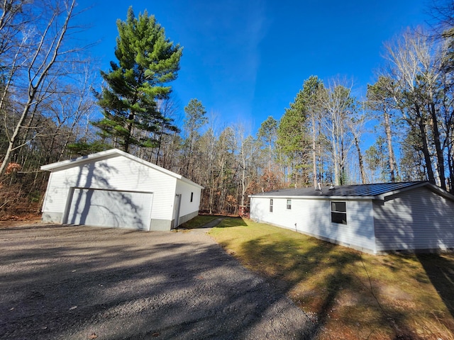 view of side of property with a garage and a yard