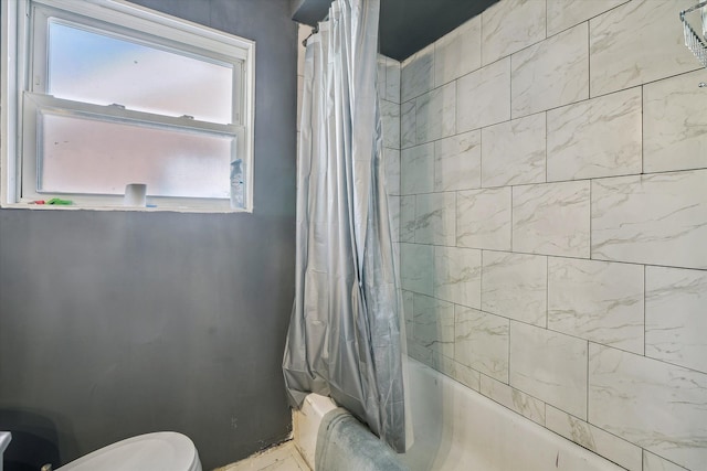 bathroom featuring toilet and shower / bath combo with shower curtain