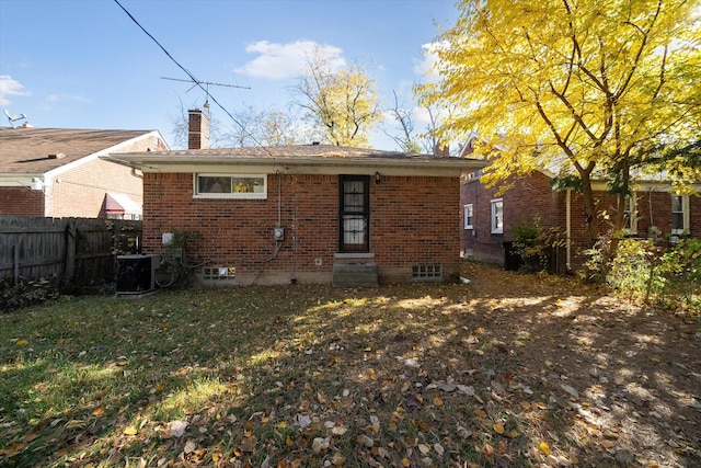 back of house with a yard and cooling unit