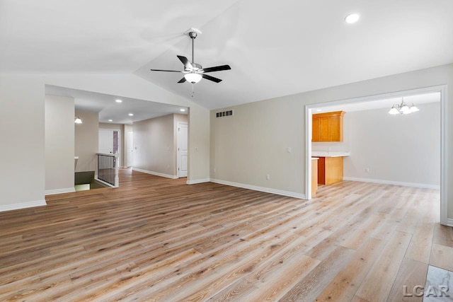 unfurnished living room featuring light wood-type flooring, lofted ceiling, and ceiling fan with notable chandelier