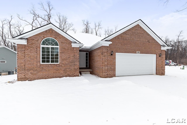 ranch-style home featuring central AC unit and a garage