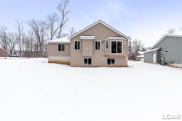 snow covered house with central AC