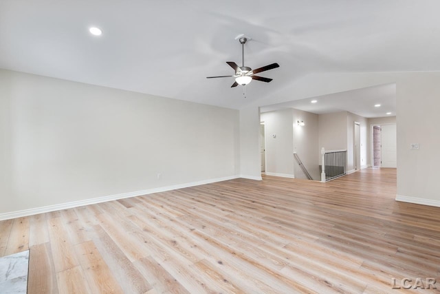 empty room featuring light hardwood / wood-style floors, lofted ceiling, and ceiling fan