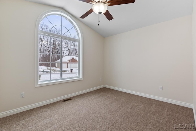 carpeted spare room featuring lofted ceiling and ceiling fan