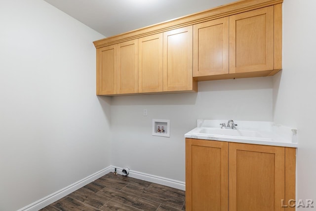 clothes washing area featuring washer hookup, cabinets, dark hardwood / wood-style flooring, and sink