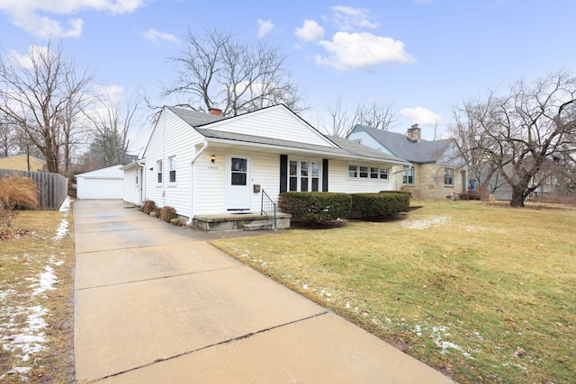 view of front of home with an outbuilding, a garage, and a front lawn