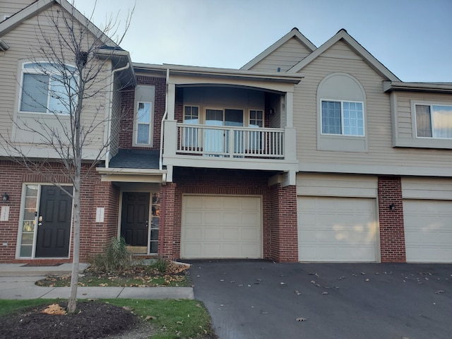 view of property featuring a balcony and a garage