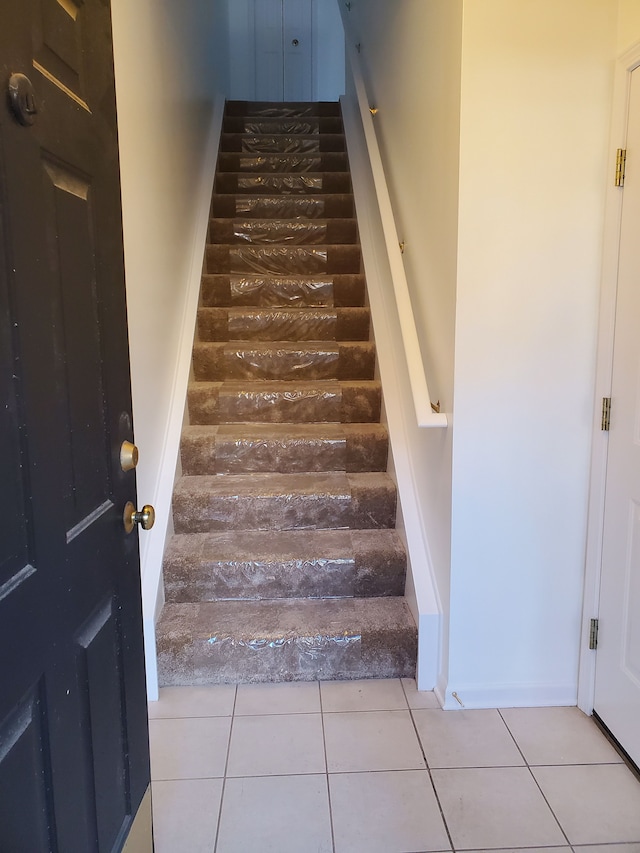 staircase with tile patterned flooring