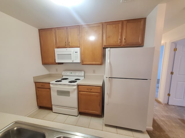 kitchen with light wood-type flooring and white appliances