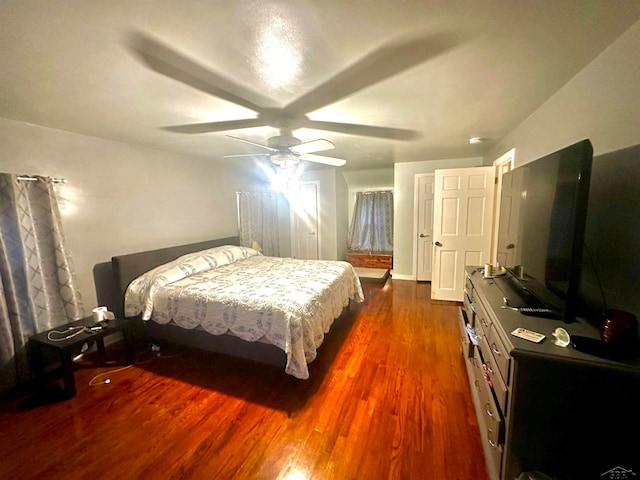 bedroom with ceiling fan and dark hardwood / wood-style floors