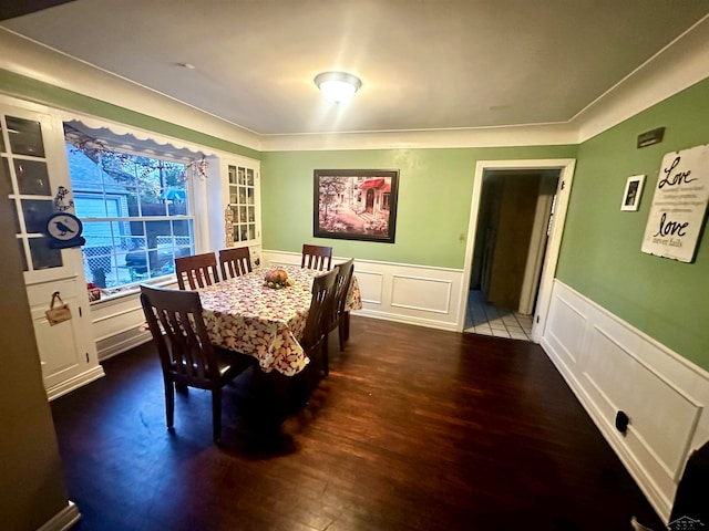 dining space with dark hardwood / wood-style floors and ornamental molding