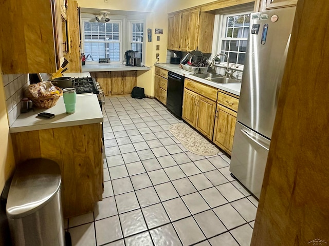 kitchen with sink, stainless steel fridge, light tile patterned floors, black dishwasher, and tasteful backsplash