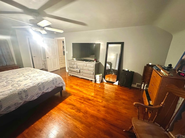 bedroom featuring ceiling fan, wood-type flooring, and vaulted ceiling