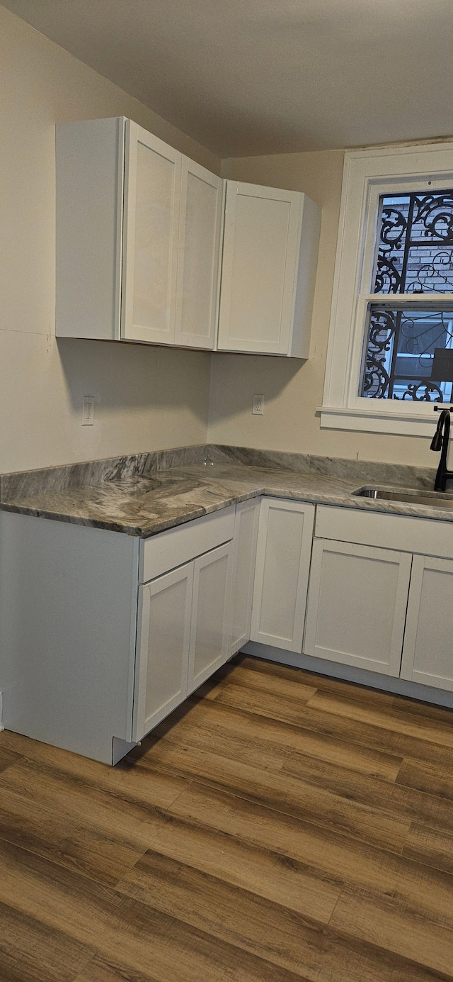 kitchen with white cabinets and dark wood-type flooring