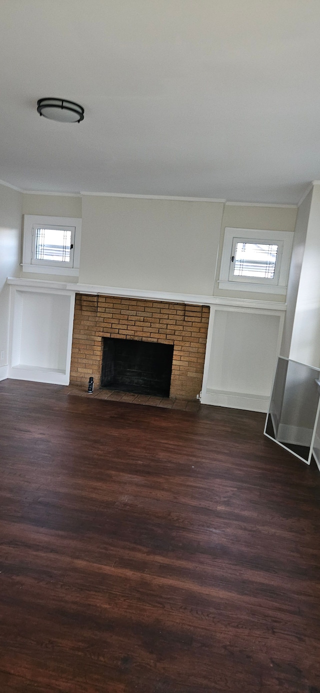 unfurnished living room featuring dark hardwood / wood-style flooring and a fireplace