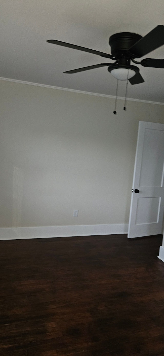 empty room featuring dark hardwood / wood-style floors, ceiling fan, and crown molding