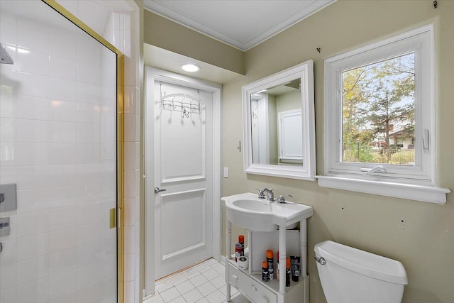 bathroom featuring toilet, tile patterned floors, a shower with door, and crown molding