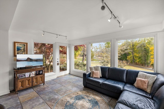 sunroom / solarium featuring track lighting