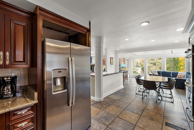 kitchen featuring visible vents, decorative backsplash, light stone countertops, stainless steel appliances, and recessed lighting