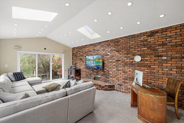 carpeted living room with lofted ceiling with skylight and brick wall