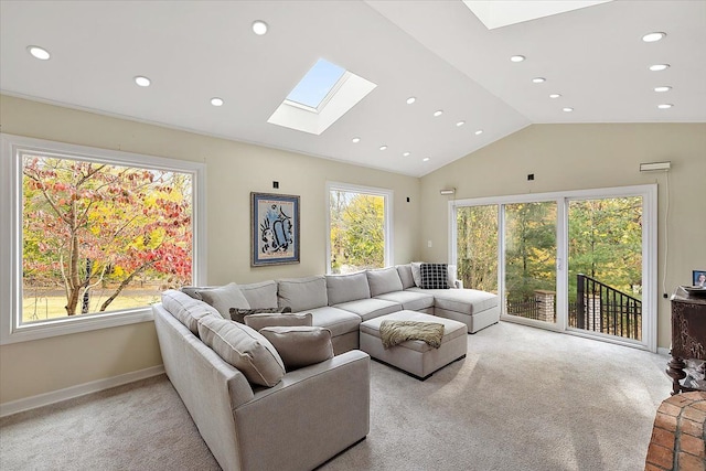 living room with vaulted ceiling with skylight and light colored carpet