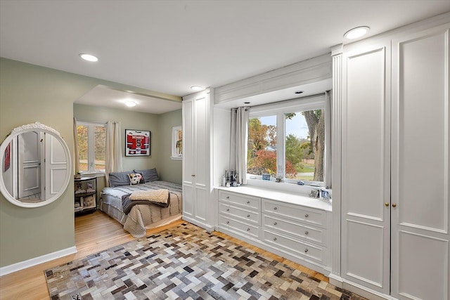 bedroom featuring multiple windows and light hardwood / wood-style floors