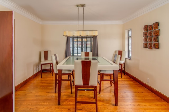 dining area featuring light hardwood / wood-style floors and ornamental molding