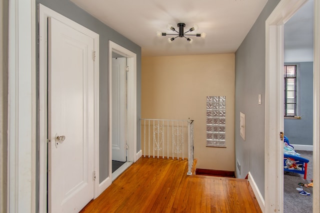 hallway with hardwood / wood-style flooring