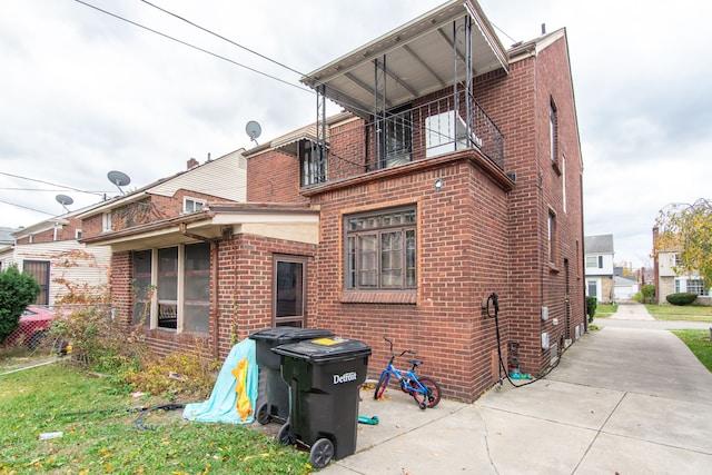 back of property with a balcony and a patio area