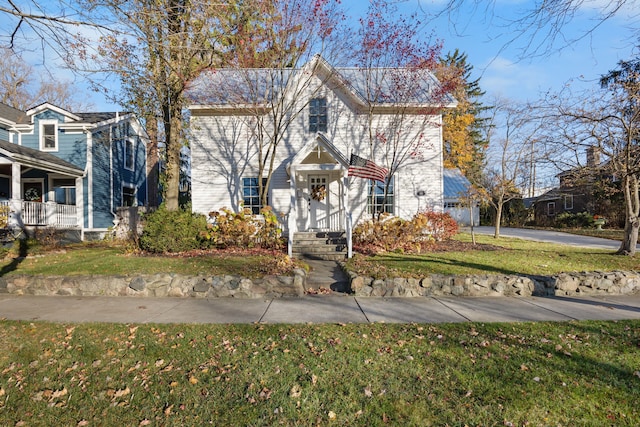 view of property featuring a front lawn