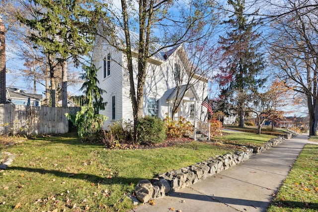 view of home's exterior with a lawn