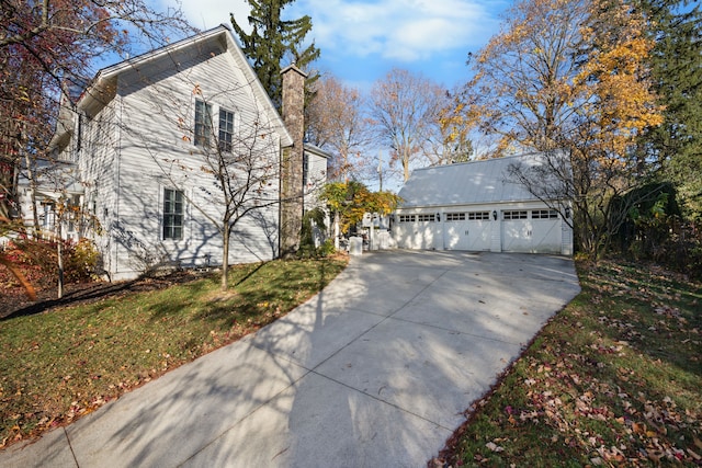 view of property exterior with an outbuilding and a garage