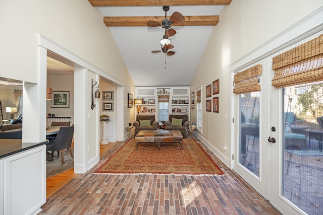 hall featuring beam ceiling and high vaulted ceiling