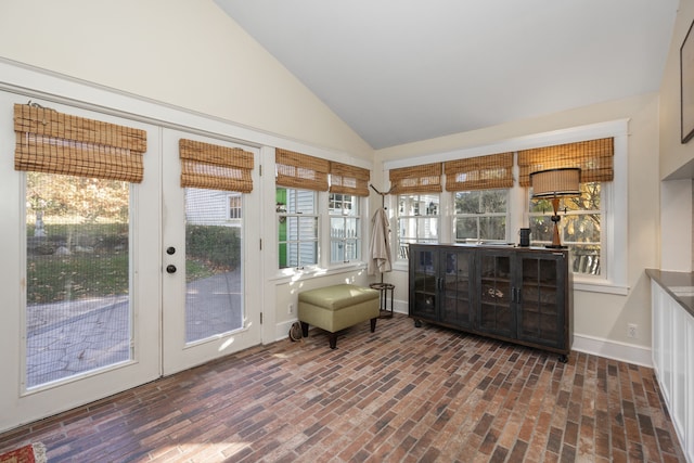 sunroom / solarium featuring lofted ceiling