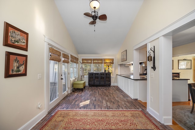 interior space featuring dark hardwood / wood-style flooring, high vaulted ceiling, and ceiling fan